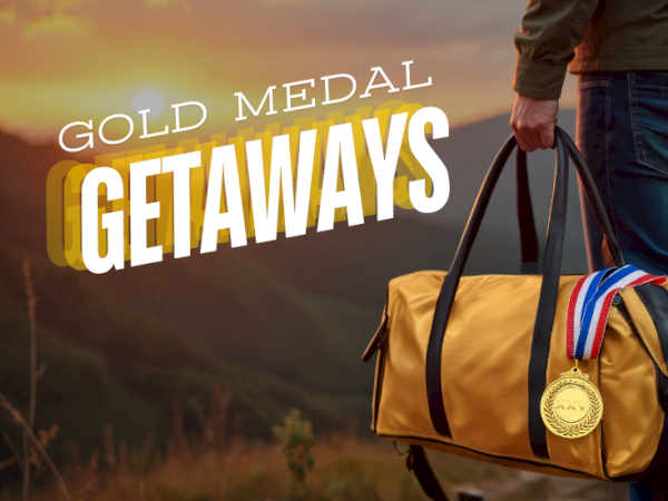 A person carries a yellow duffel bag with a gold medal and ribbon at sunrise, promo text reading &ldquo;Gold Medal Getaways.&rdquo;